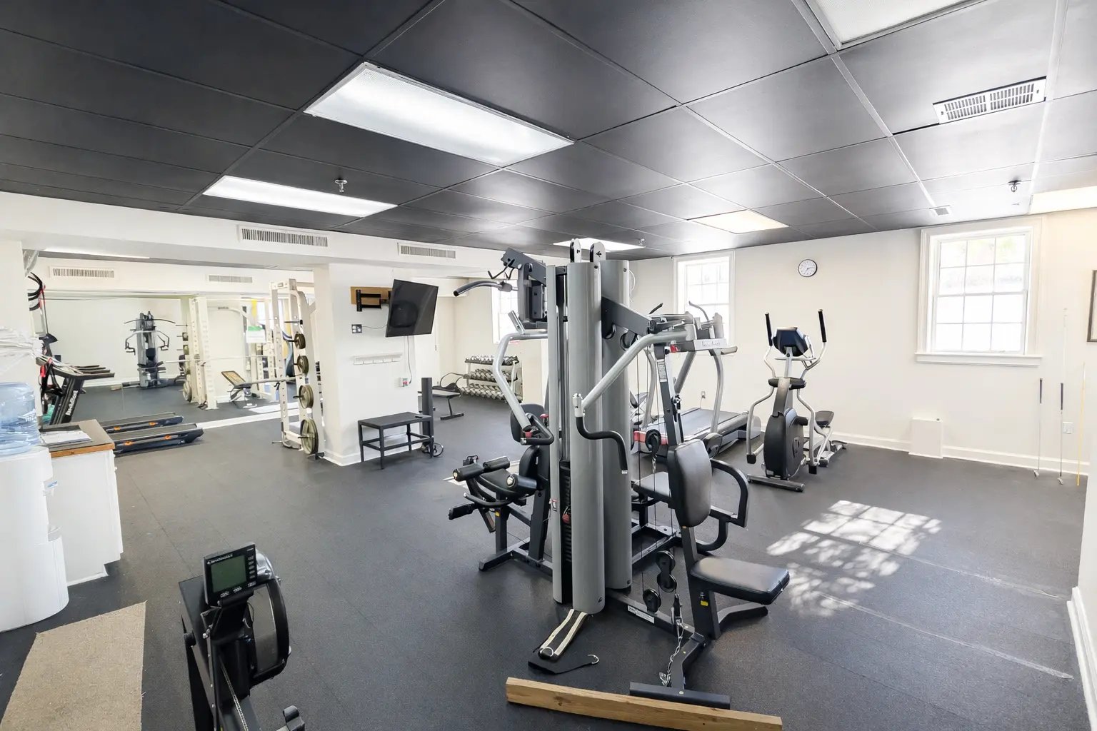 man flexing his muscles in a gym